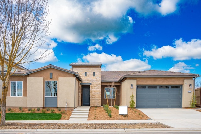 view of front facade with stone siding, stucco siding, concrete driveway, and a garage