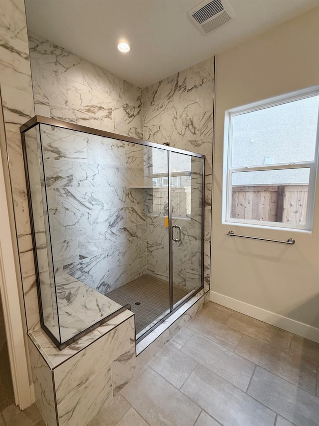 bathroom with a marble finish shower, visible vents, recessed lighting, and baseboards