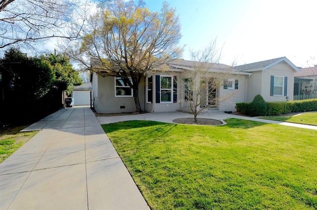 back of house featuring stucco siding, a yard, and driveway