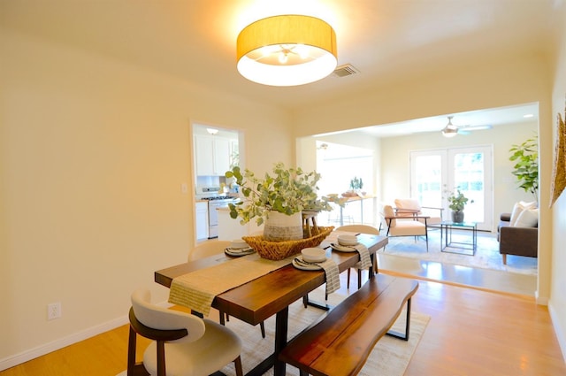 dining area featuring visible vents, french doors, baseboards, and light wood-style floors