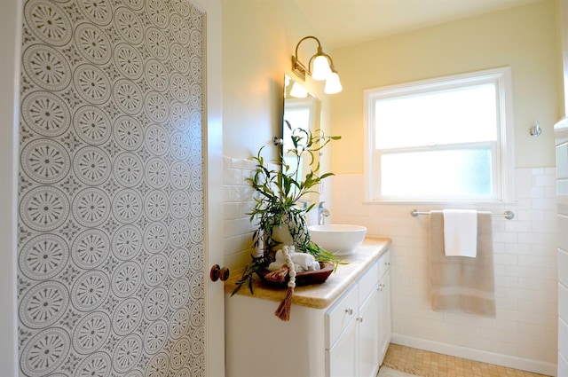 full bathroom with a shower, wainscoting, tile walls, and vanity