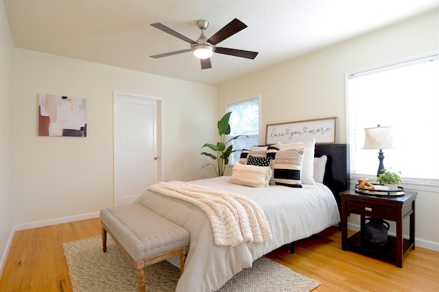 bedroom featuring baseboards, ceiling fan, and light wood finished floors