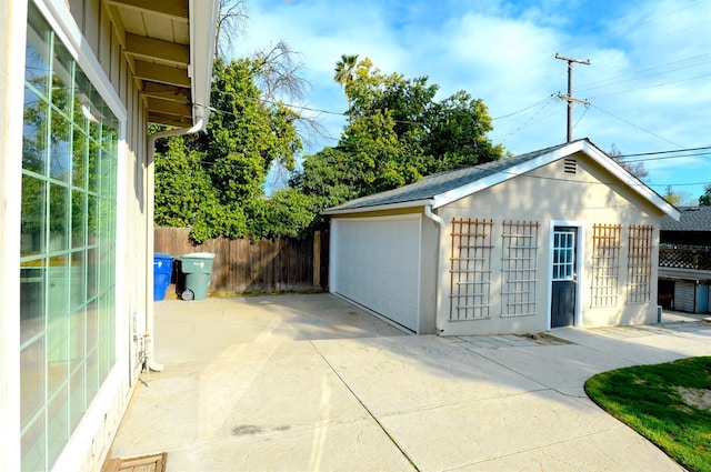 detached garage featuring fence