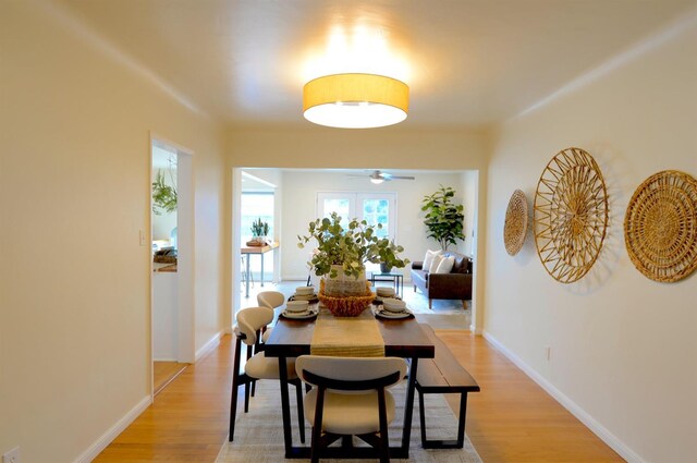 dining room featuring baseboards and light wood finished floors