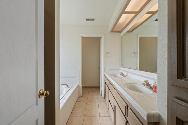 full bath featuring tile patterned floors, visible vents, a sink, double vanity, and a bath