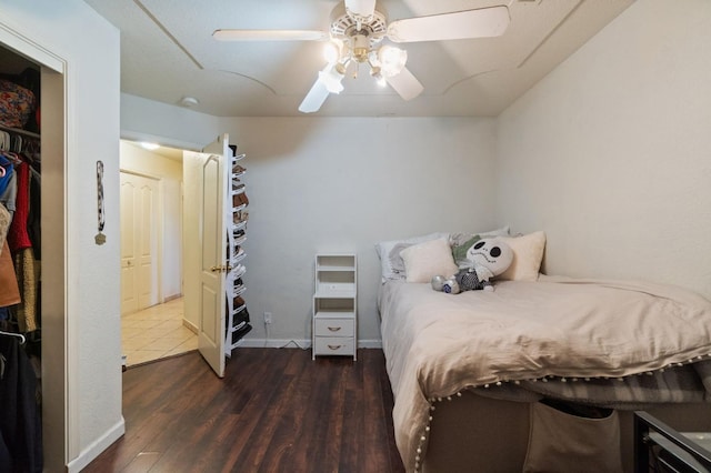 bedroom with ceiling fan, baseboards, and dark wood-style floors