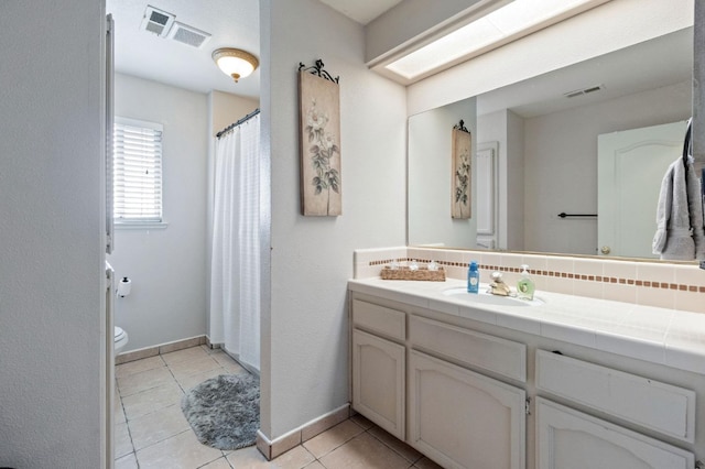 full bathroom featuring vanity, tile patterned floors, toilet, and visible vents