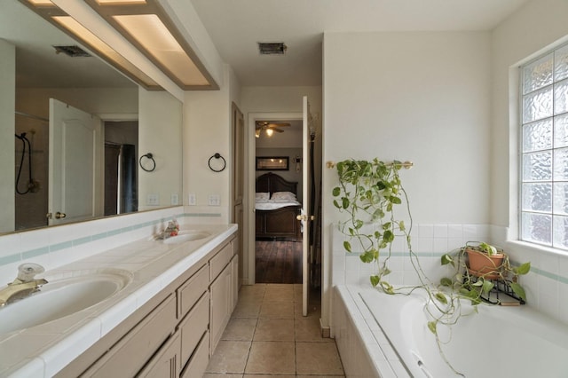 ensuite bathroom with visible vents, a wealth of natural light, and a sink