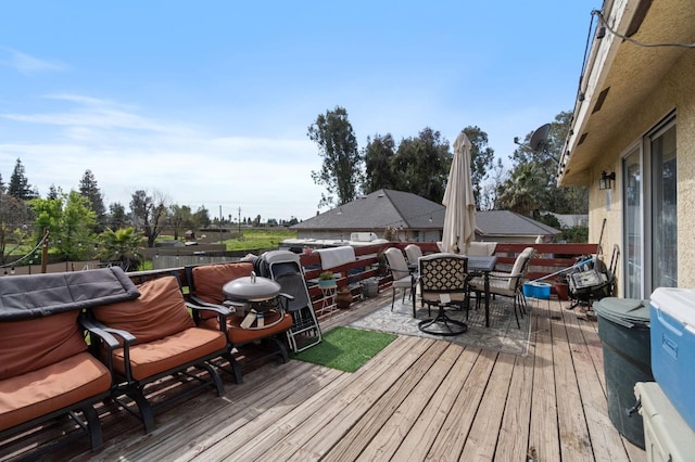 wooden terrace featuring outdoor dining space