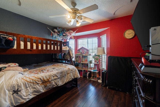 bedroom featuring hardwood / wood-style floors, a ceiling fan, a textured wall, and a textured ceiling