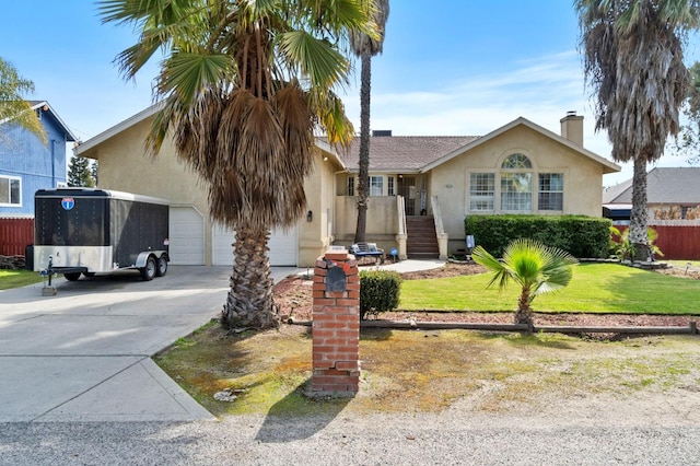 view of front of house with a front yard, an attached garage, a chimney, stucco siding, and concrete driveway