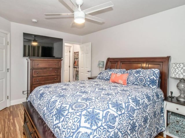 bedroom featuring baseboards, a ceiling fan, and wood finished floors