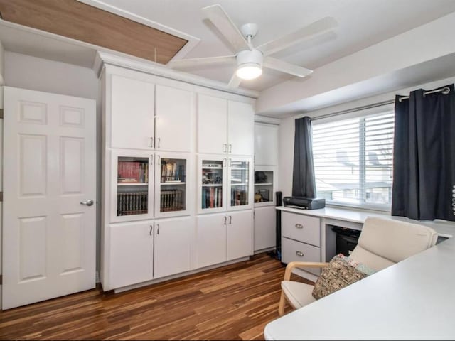 kitchen with dark wood-style floors, white cabinetry, light countertops, and a ceiling fan