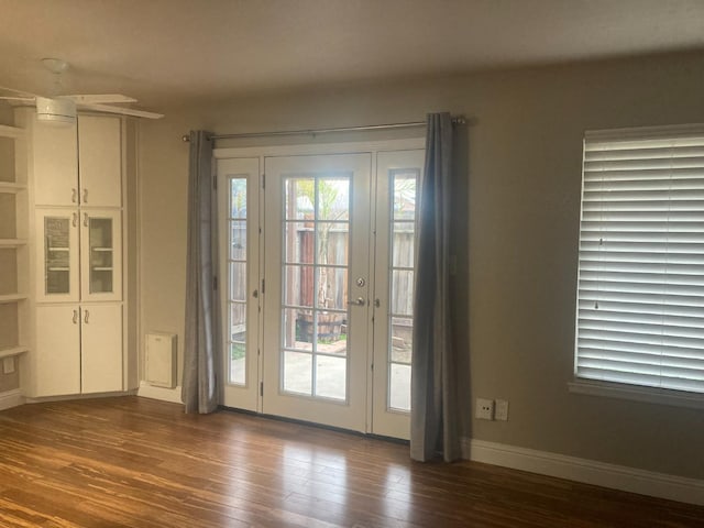 doorway to outside with baseboards and dark wood-type flooring