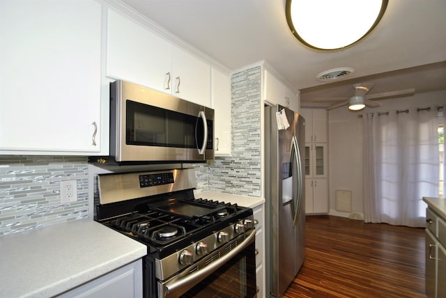 kitchen with dark wood-style floors, visible vents, stainless steel appliances, light countertops, and white cabinetry