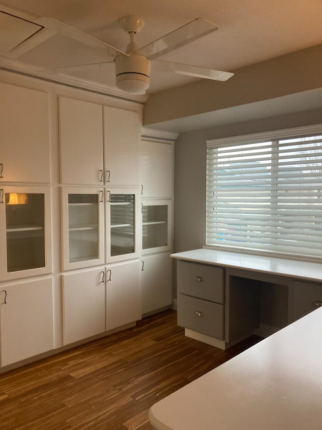 unfurnished bedroom featuring dark wood-type flooring, a closet, and built in study area