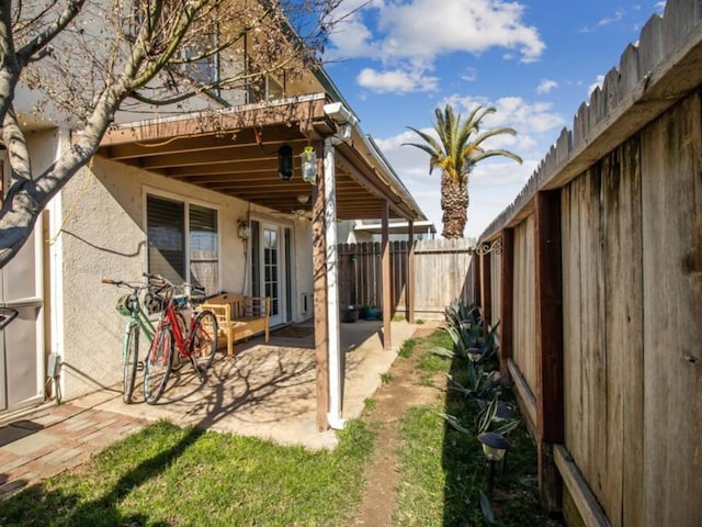 exterior space with a patio area and a fenced backyard