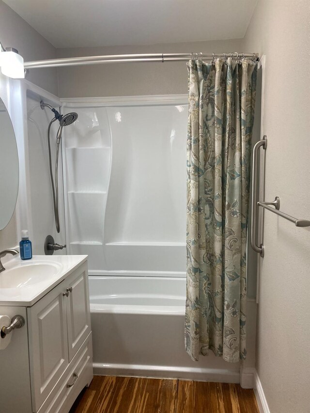 bathroom featuring vanity, shower / tub combo, and wood finished floors