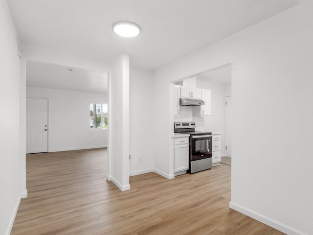 kitchen featuring white cabinetry, stainless steel electric stove, light wood-style floors, and under cabinet range hood