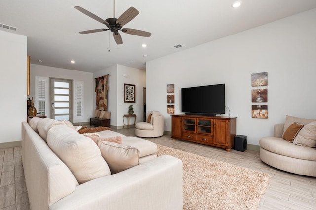 living room featuring recessed lighting, visible vents, and light wood-style floors