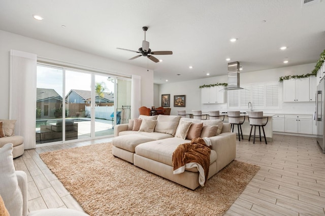 living room with visible vents, recessed lighting, light wood-style floors, and ceiling fan