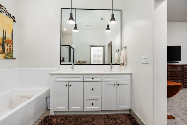 full bath featuring a sink, visible vents, a garden tub, and double vanity