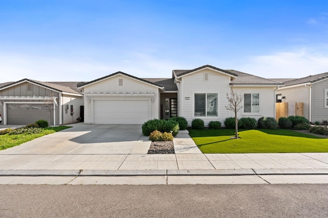 ranch-style home with a front lawn, an attached garage, and driveway