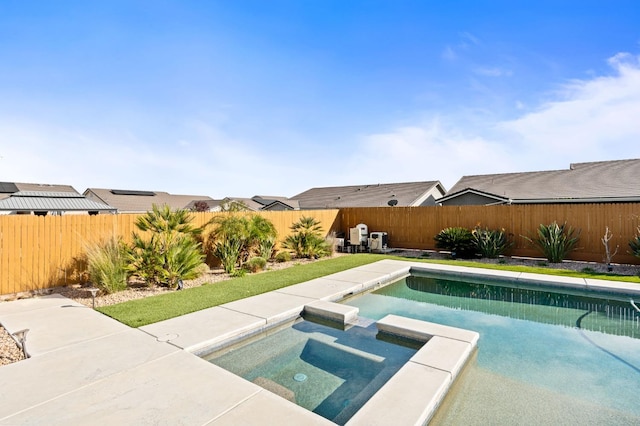 view of pool featuring a pool with connected hot tub and a fenced backyard