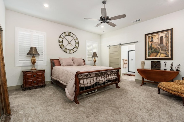 bedroom with carpet, visible vents, recessed lighting, ensuite bathroom, and a barn door