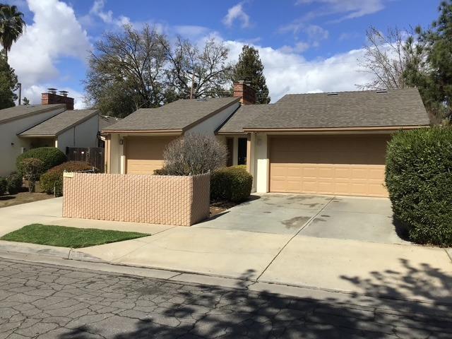 single story home featuring a garage, fence, driveway, and stucco siding