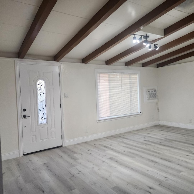 foyer entrance featuring light wood-style flooring, baseboards, and a wall mounted air conditioner