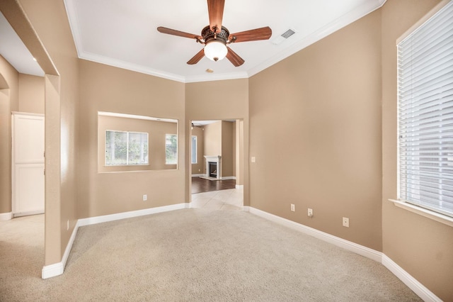 2565 Powers Ave, Clovis, CA 93619 - unfurnished room with visible vents, baseboards, ornamental molding, ceiling fan, and light carpet