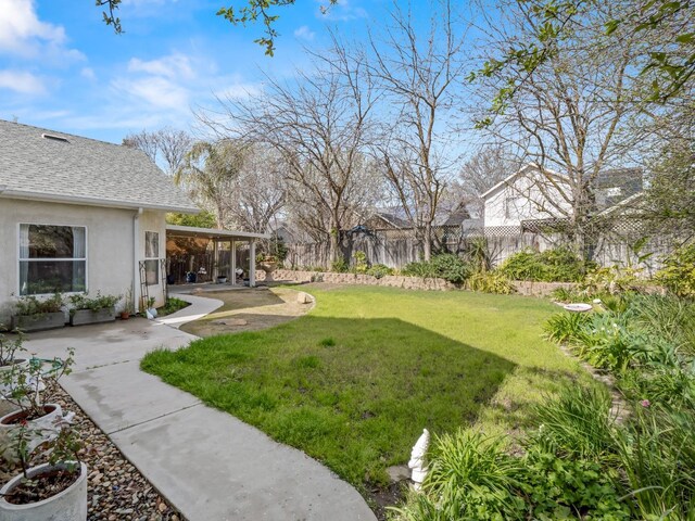 view of yard featuring a patio area and fence