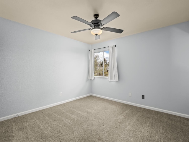 spare room with baseboards, ceiling fan, and carpet flooring