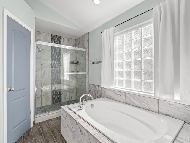 full bath with vaulted ceiling, a garden tub, and a shower stall