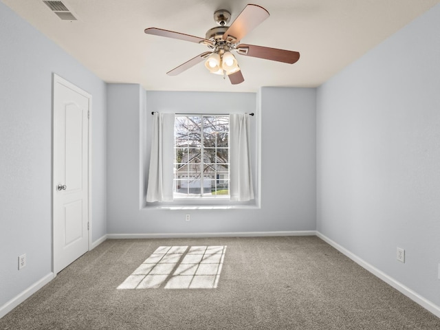 unfurnished room with visible vents, baseboards, ceiling fan, and carpet flooring