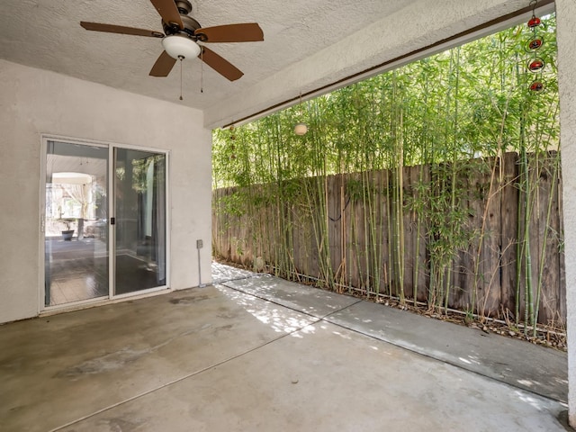 view of patio / terrace with a ceiling fan and fence