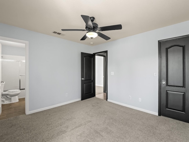 unfurnished bedroom featuring visible vents, connected bathroom, baseboards, and carpet floors