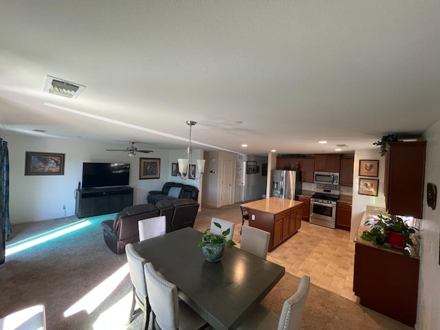 dining space featuring light carpet, recessed lighting, visible vents, and ceiling fan