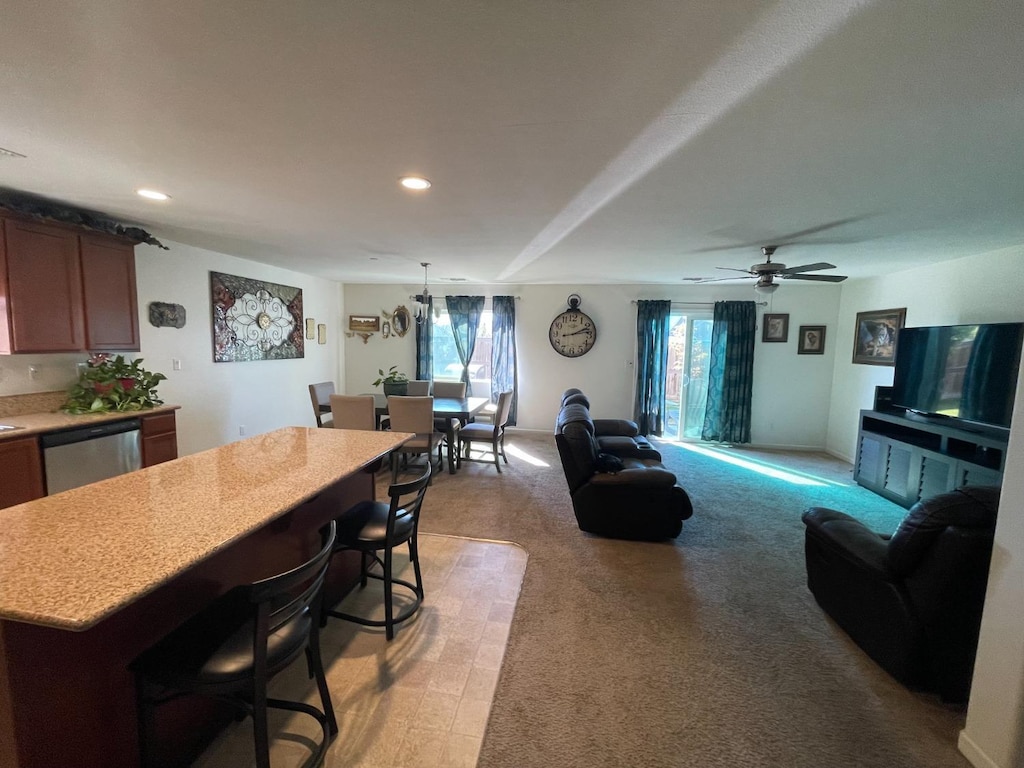 interior space featuring recessed lighting, baseboards, light colored carpet, and a ceiling fan