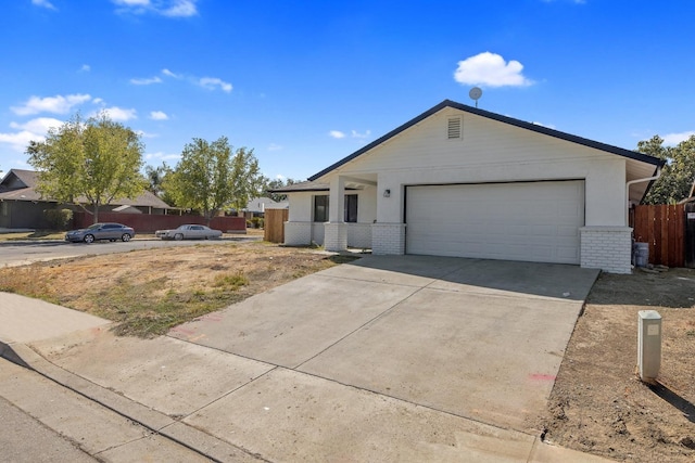 ranch-style home featuring a garage, brick siding, concrete driveway, and fence