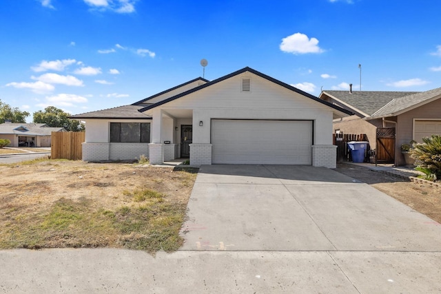 ranch-style home featuring brick siding, concrete driveway, a garage, and fence