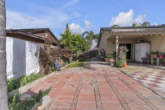 view of patio featuring fence