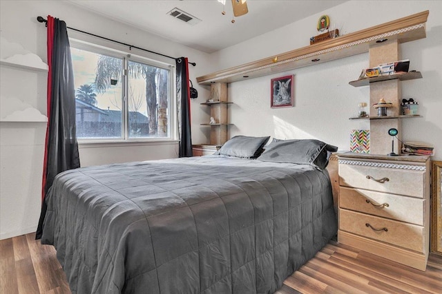 bedroom with visible vents and wood finished floors