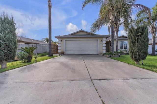 single story home with stucco siding, fence, concrete driveway, a front yard, and a garage