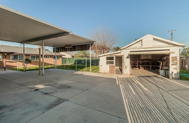 exterior space featuring an outbuilding and fence