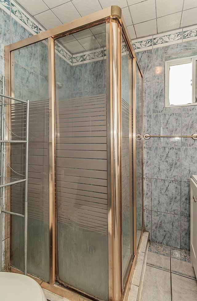 full bathroom featuring tile patterned flooring and a shower stall