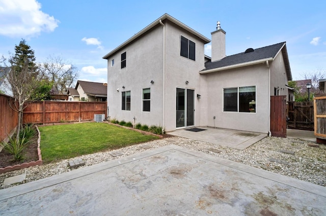 rear view of property featuring stucco siding, a patio, a fenced backyard, a yard, and central AC unit