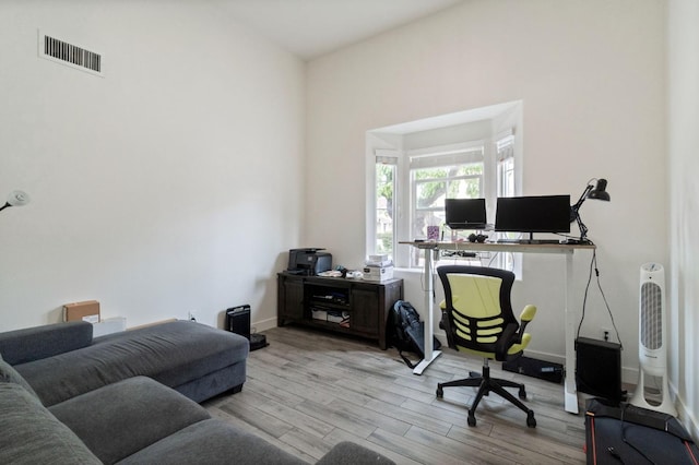 home office with visible vents, baseboards, and wood finished floors