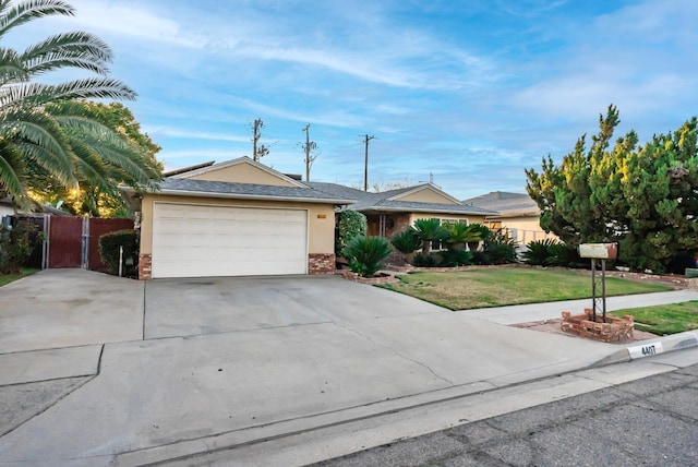 ranch-style home featuring a front yard, driveway, an attached garage, stucco siding, and brick siding